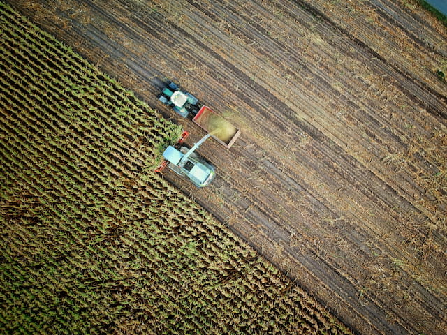 Agricultural tractors working in a field for GNSS-guided precision farming operations