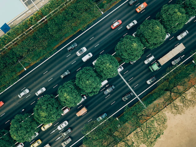 Aerial view of cars and trucks traveling on a divided multi-lane road
